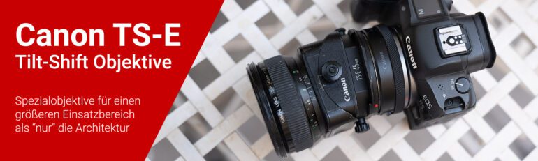 Eine Fotokamera (Canon EOS R5) mit Adapter und 45mm Tilt-Shift Objektiv liegt auf einem weißen Gartentisch